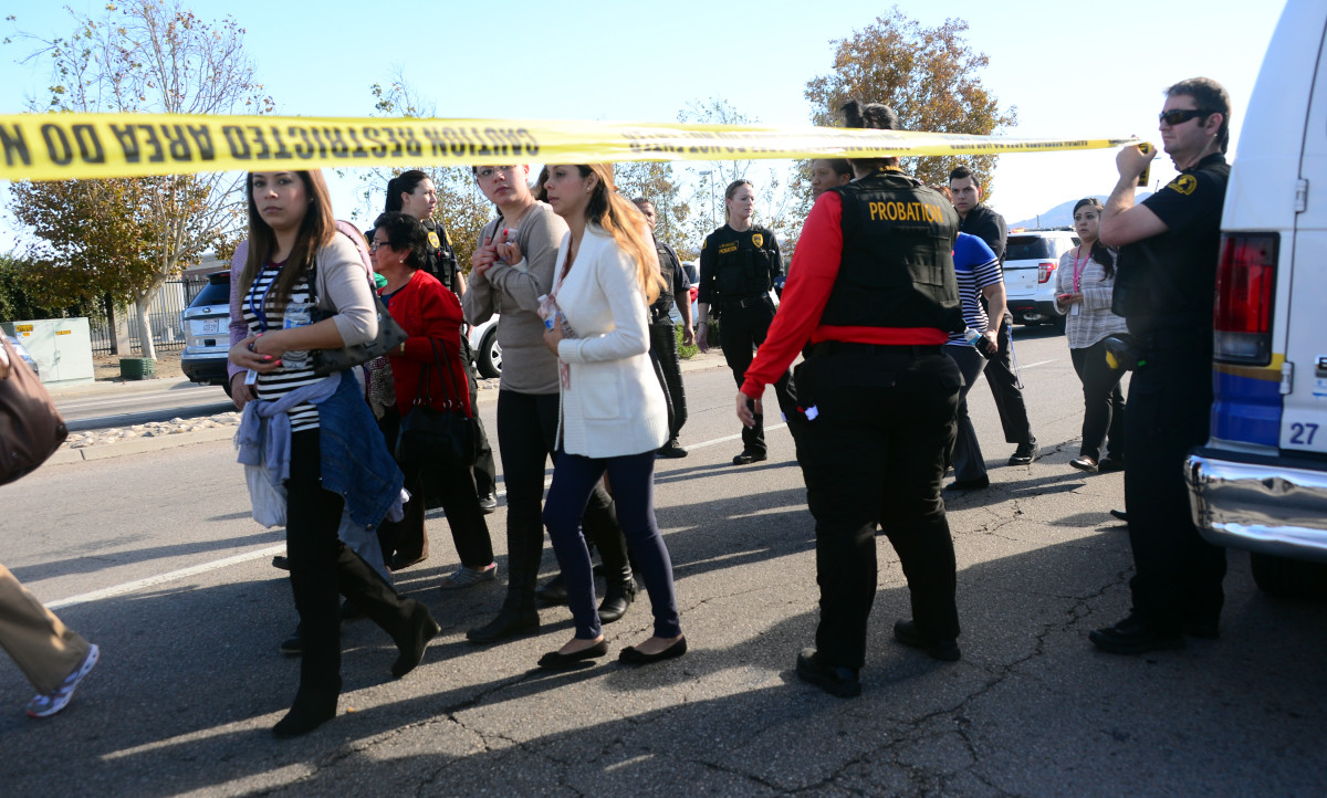 Survivors are evacuated from the scene of a shooting under police escort on December 2, 2015, in San Bernardino, California. (Photo: Frederic J. Brown/AFP/Getty Images)