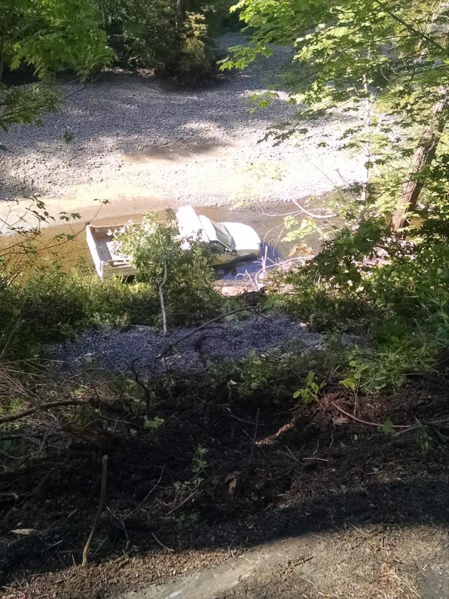 Near the author's cabin, a truck rolled off the road and into the river. (Photo: Alexis Coe)