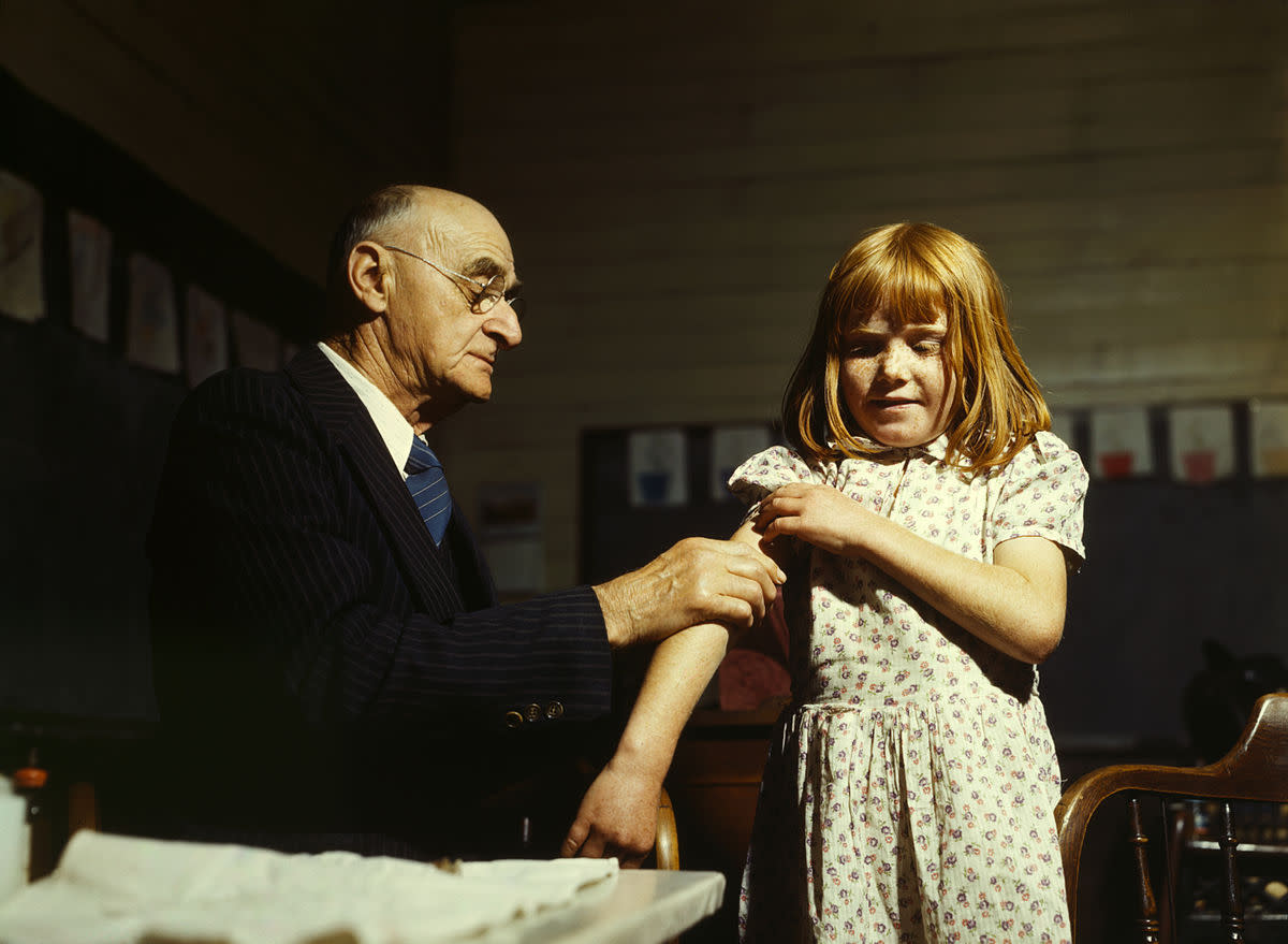 A doctor performing a typhoid vaccination in Texas, 1943.