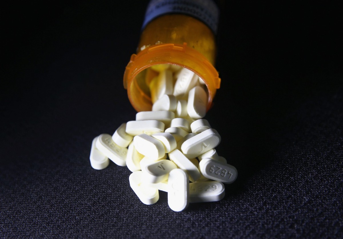 Photo showing pills spilling out of a prescription bottle