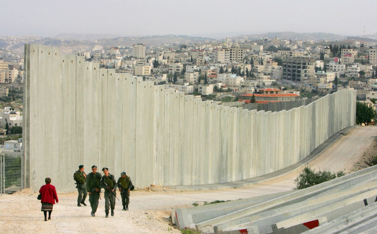 Israeli soldiers patrol in East Jerusalem along the concrete separation barrier bordering Abu Dis, West Bank, in 2006.