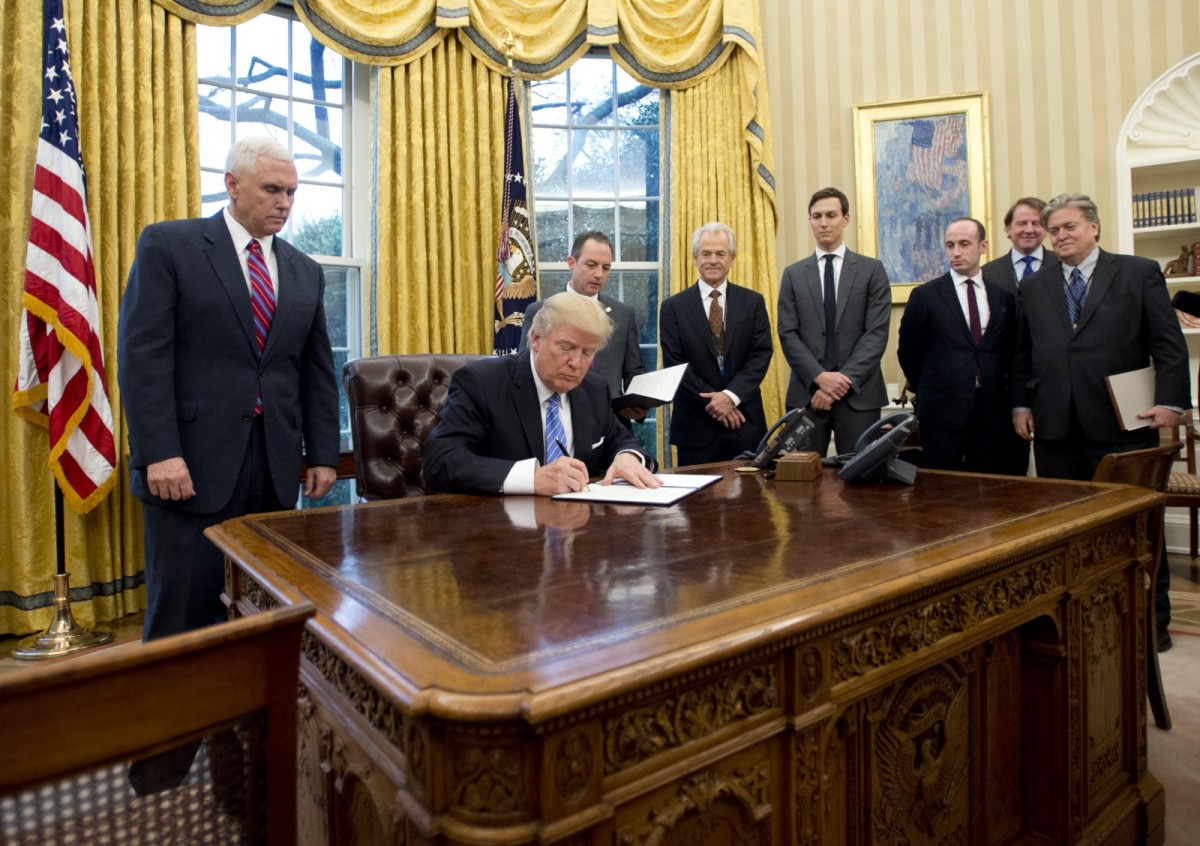 Donald Trump signs an executive order in the White House.