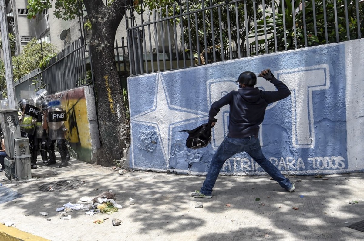 An activist clashes with riot police during a protest against Nicolás Maduro’s government in Caracas, Venezuela, on April 4th, 2017. (Photo: Juan Barreto/AFP/Getty Images)