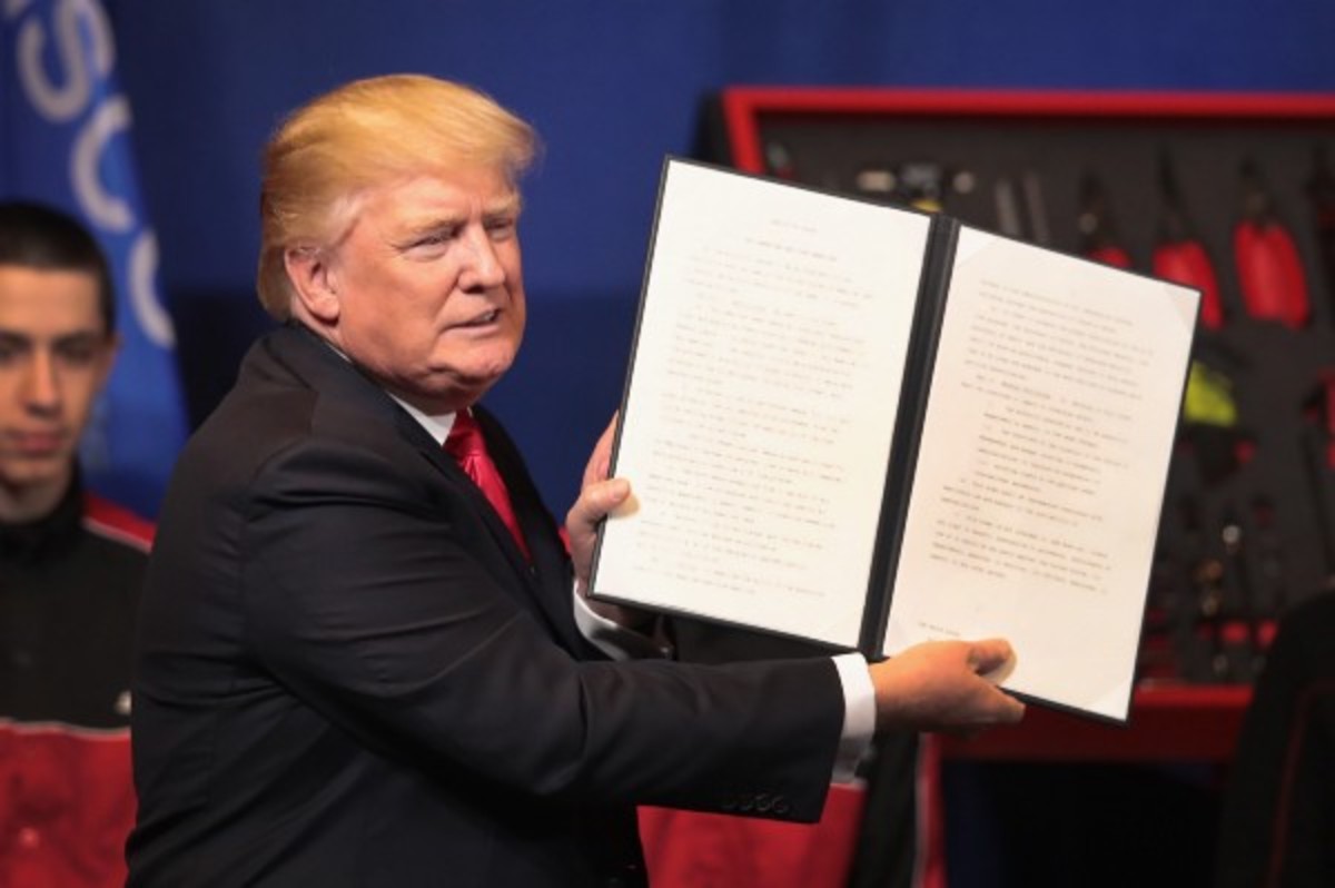 President Donald Trump signs an executive order to try to bring jobs back to American workers and revamp the H-1B visa guest worker program on April 18th, 2017, in Kenosha, Wisconsin.