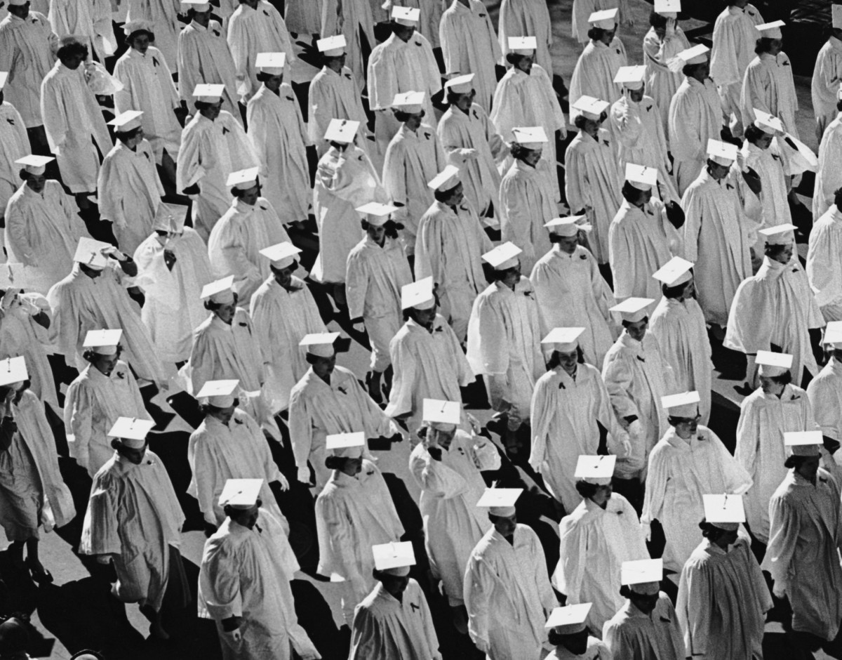 A black and white image of graduates in their robes.