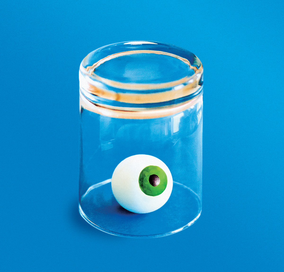 An illustration of an eyeball inside an upturned glass.