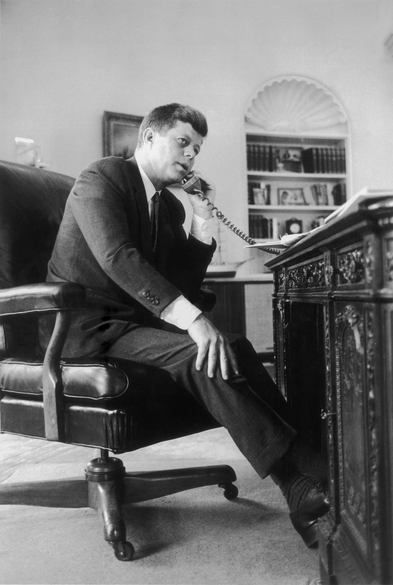 John F Kennedy, the 35th president of the United States, making a telephone call.