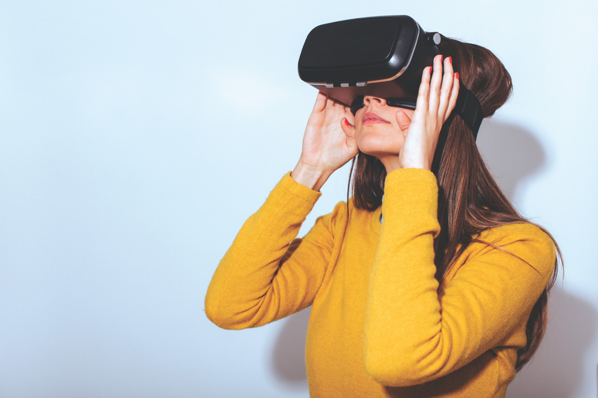 A woman wears a virtual-reality headset.