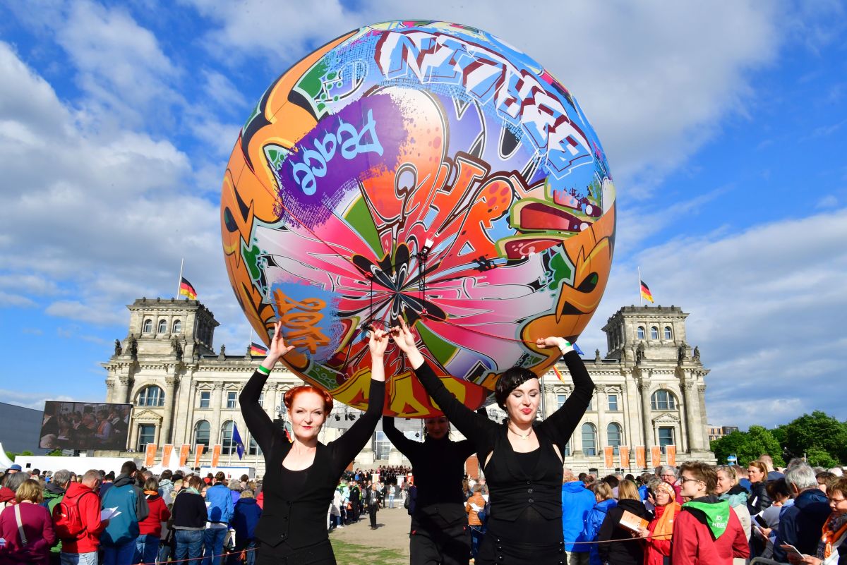 Performers carry a giant graffiti ball during the opening Mass of the Kirchentag (Church Day) festival in Berlin, Germany, celebrating the 500th anniversary of the Reformation, on May 24th, 2017.