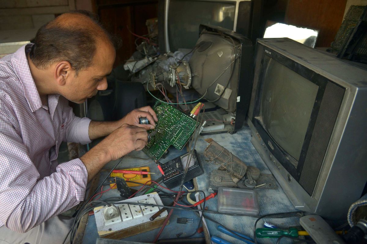 Indian television repairman Balwinder Pal works at his shop in Amritsar on May 26th, 2017.