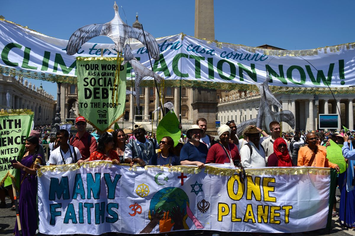 Activists display banners calling for action on climate change and against world poverty as they arrive on St. Peter's Square prior to Pope Francis' Sunday Angelus prayer at the Vatican.