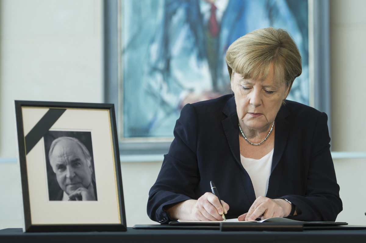 German Chancellor Angela Merkel writes in a condolences book for former chancellor Helmut Kohl on June 18th, 2017, in Berlin, Germany.