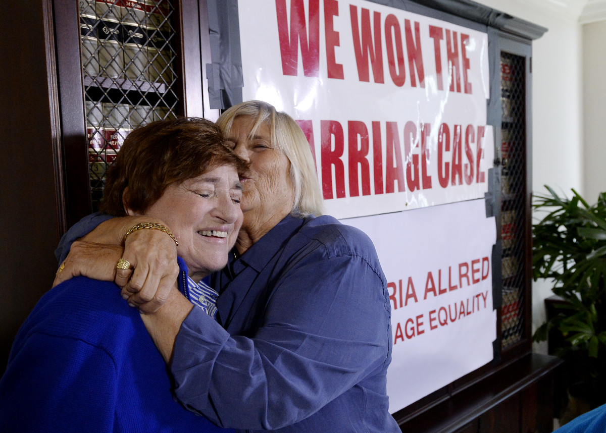 Same-sex couple Diane Olson (R) kisses her spouse Robin Tyler at attorney Gloria Allred's office reacting to Supreme Court's decision on same sex-marriage after a news conference on June 26th, 2015, in Los Angeles, California.