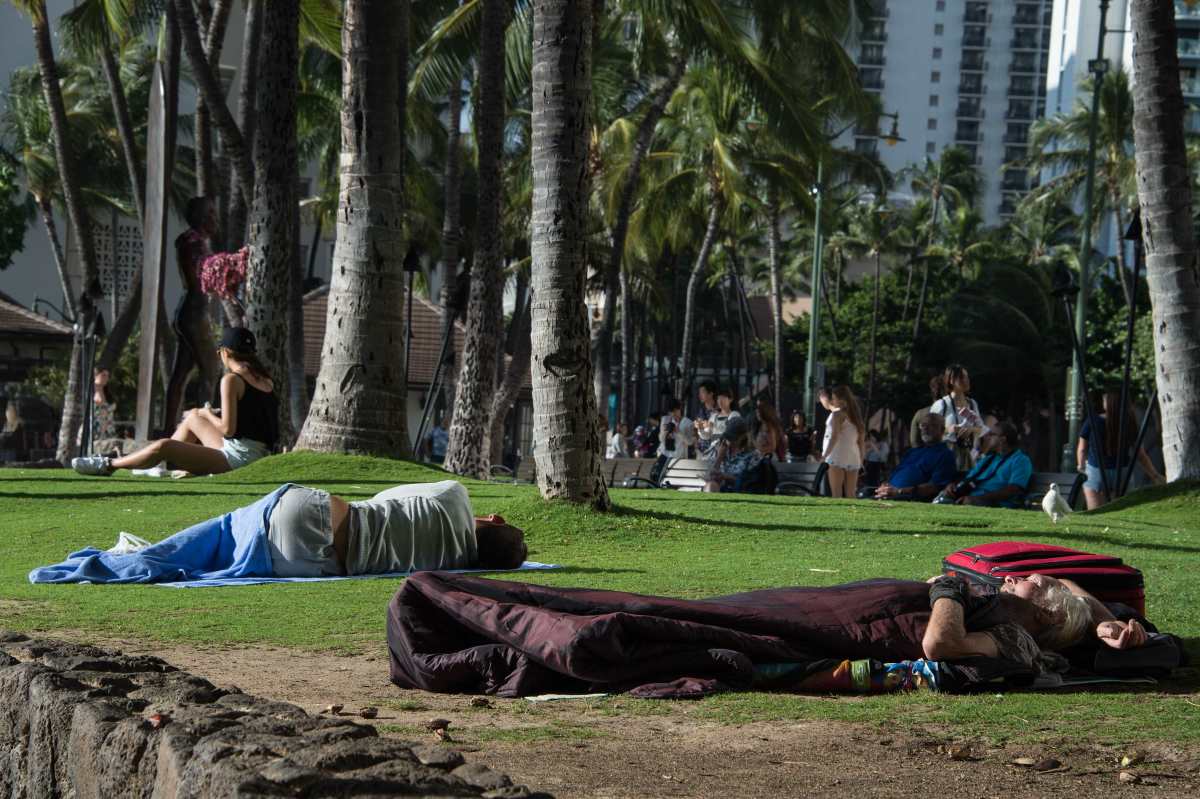 Homeless people sleep in a park off in Honolulu, Hawaii, on December 17th, 2016.