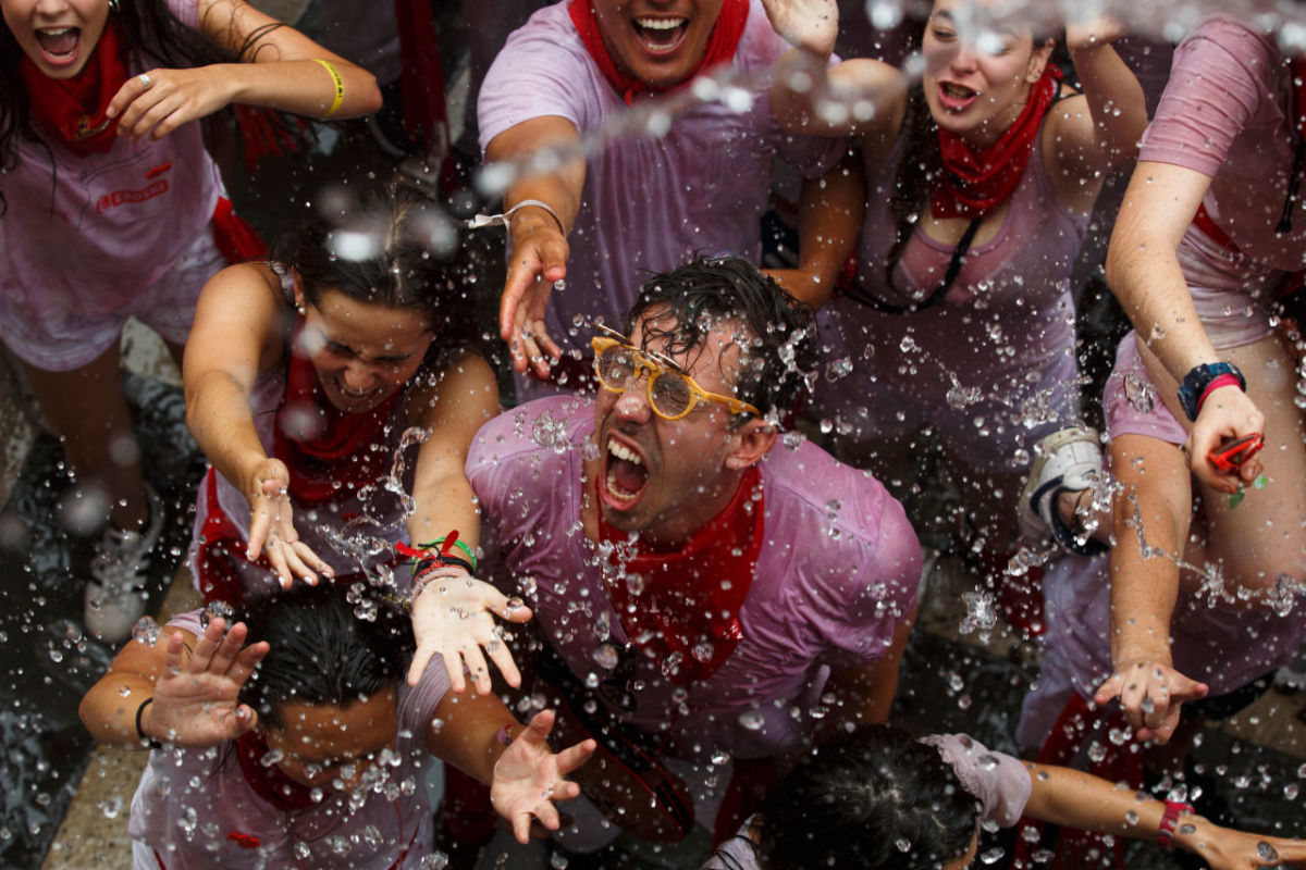 Revellers enjoy the atmosphere during the opening day, or "Chupinazo," of the San Fermin Running of the Bulls fiesta on July 6th, 2017, in Pamplona, Spain. The annual Fiesta de San Fermin involves the daily running of the bulls through the historic heart of Pamplona to the bull ring.