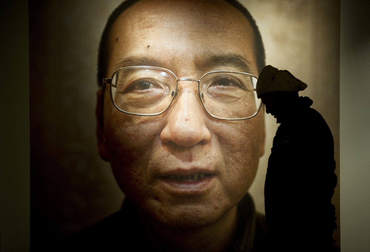 A man walks in front of a poster of Liu Xiaobo at an exhibition at the Nobel Peace Center in Oslo, Norway, on December 9th, 2010.
