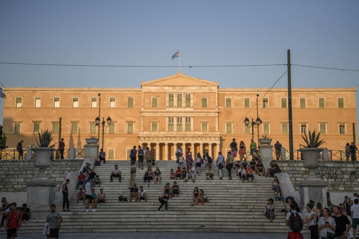 People gather in front of the Greek Parliament in Athens on July 12th, 2017, the day the European Union recommended that Greece has made enough progress in balancing its budget to be removed from special oversight of government spending. The move is a further boost for Athens days after it secured a fresh tranche of cash from its latest bailout to meet crucial debt payments and avoid a fresh crisis.