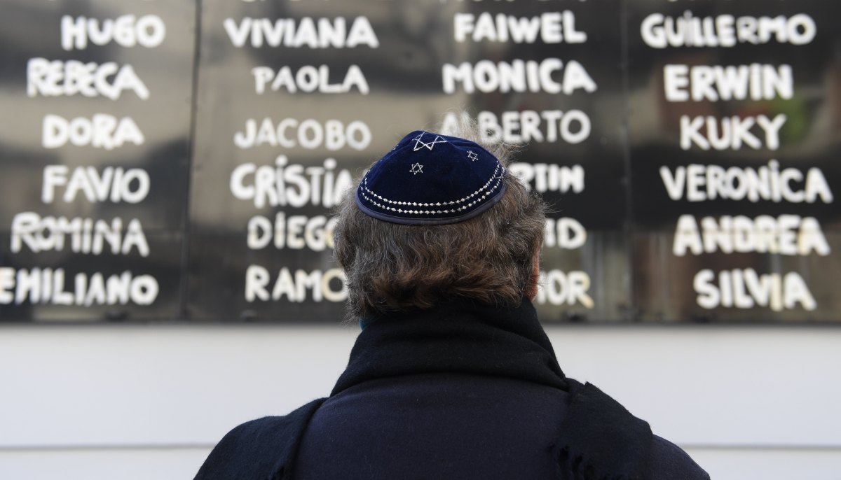 A man prays in front of the Argentine Israelite Mutual Association Jewish community center during the commemoration of the 23rd anniversary of the terrorist bombing attack that killed 85 people and injured 300, in Buenos Aires on July 18th, 2017.