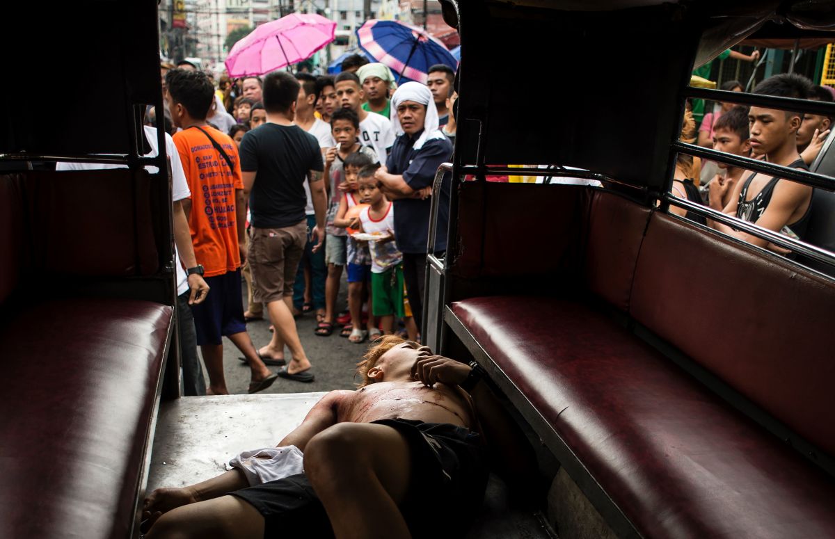 The body of an alleged drug dealer is seen inside a Jeepney after a large-scale anti-drug raid by the police at a slum community in Manila, the Philippines, on July 20th, 2017.