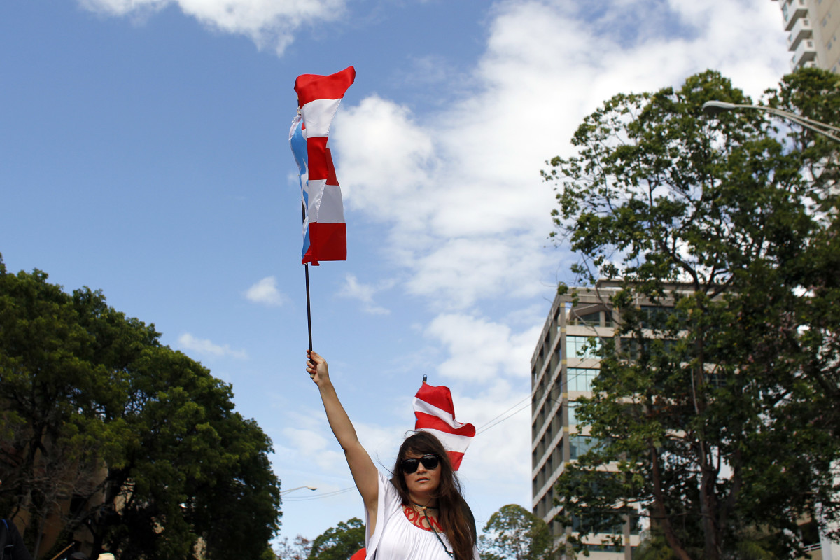 A woman waves a Puerto Rican flag during a protest against the referendum for Puerto Rico political status in San Juan, on June 11th, 2017.