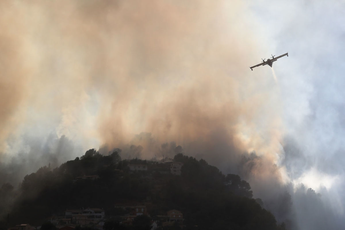 A fire-fighting Canadair aircraft flies to drop water over a fire near Carros, southeastern France, on July 24th, 2017.