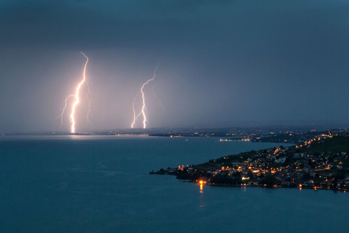 Lightning illuminates the night sky over the village of Cully surrounded by the vineyard terraces of Lavaux on the bank of Leman Lake from Chexbres on late July 30th, 2017.