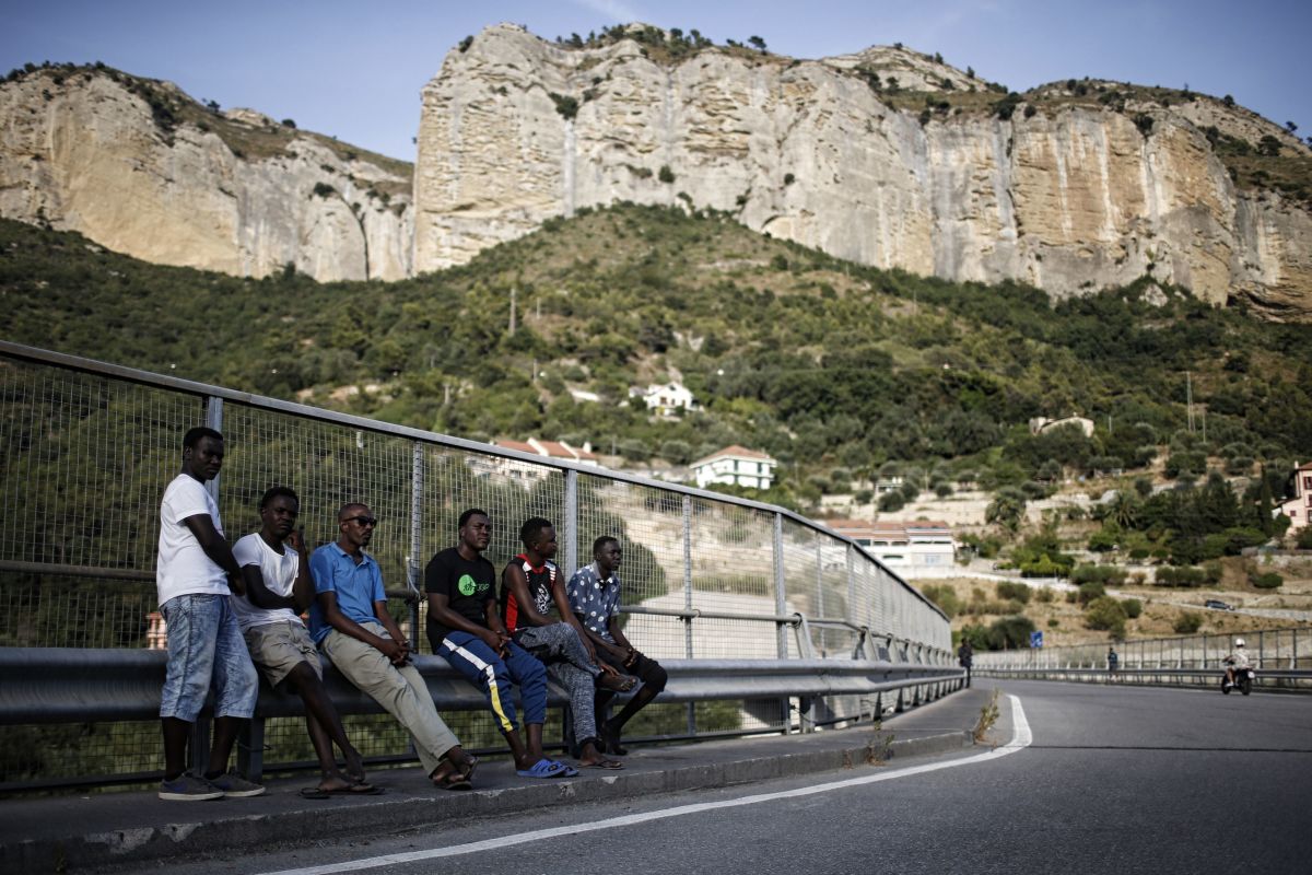 Migrants walk next to the Roya River on August 8th, 2017, in Ventimiglia, close to the French border.