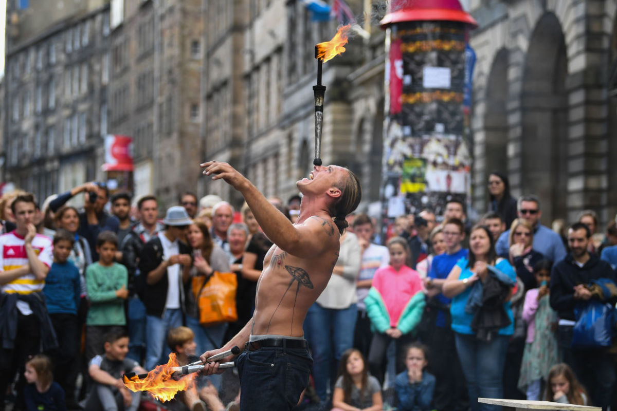 Edinburgh Festival Fringe entertainers perform on the Royal Mile on August 7th, 2017, in Edinburgh, Scotland. This year marks the 70th anniversary of the largest performing arts festival in the world, with an excess of 30,000 performances of more than 2,000 shows.