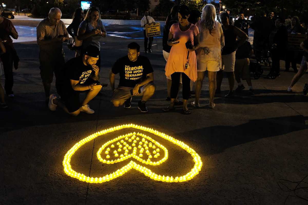 People attend a candlelight vigil for victims of drug addiction on August 24th, 2017, in the borough of Staten Island in New York City. Dozens of Staten Island residents attended the evening vigil which celebrated the lives and gave remembrance to those that have died from drug addiction.