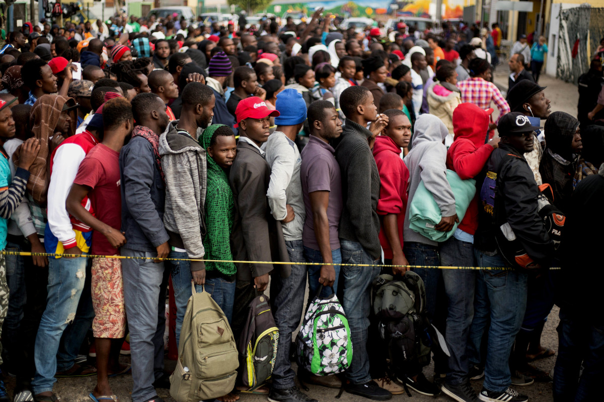 Haitian and African migrants seeking asylum in the United States line up outside a Mexican Migration office on October 3rd, 2016, in Tijuana, Mexico.
