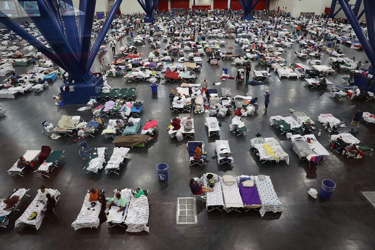 People take shelter at the George R. Brown Convention Center after floodwaters from Hurricane Harvey inundated the city on August 29th, 2017, in Houston, Texas. The evacuation center, which is overcapacity, has already received more than 9,000 evacuees, with more arriving.