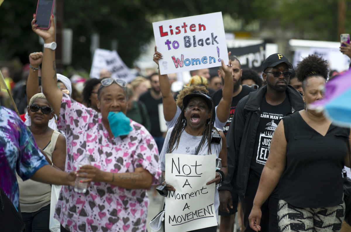Marchers walk through the Homewood neighborhood during the Black Brilliance Collective: March and Gathering in Pittsburgh, Pennsylvania, on August 19th, 2017.