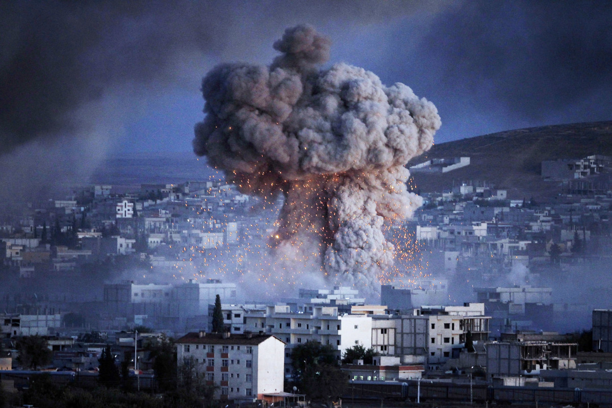 An explosion rocks Kobani, Syria, during a reported suicide car bomb attack by the ISIS militants on October 20th, 2014.