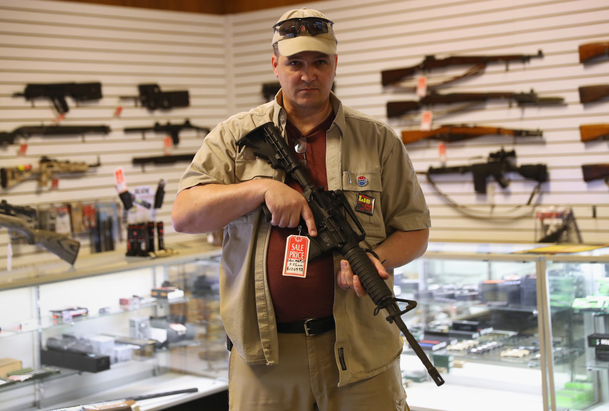Shop owner Jeff Binkley displays an AR-15 'Sport' rifle at Sarge's Sidearms on September 29, 2016 near Benson, Arizona. He said he redesigned and renamed his store just this year. Gun shops are proliferate in Arizona, which regulates and restricts weapons less than anywhere in the United States.