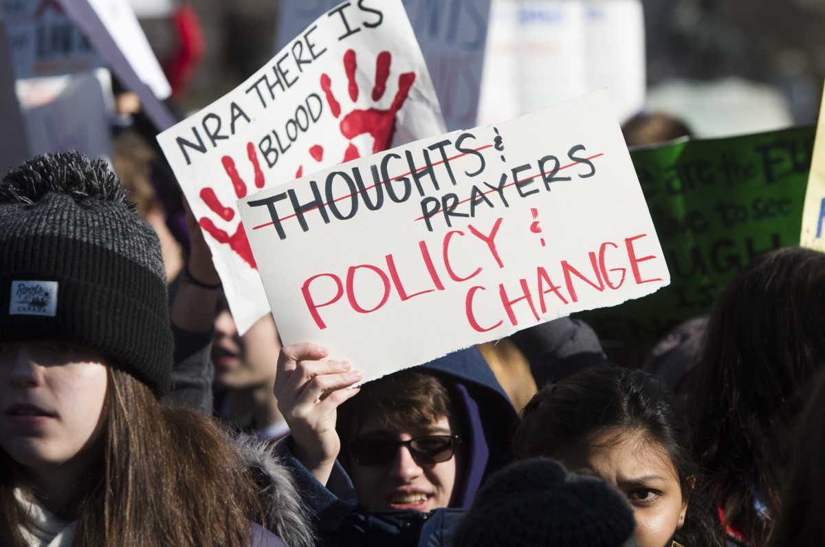 Students hold up signs demanding stricter gun control in front the White House in Washington, D.C.