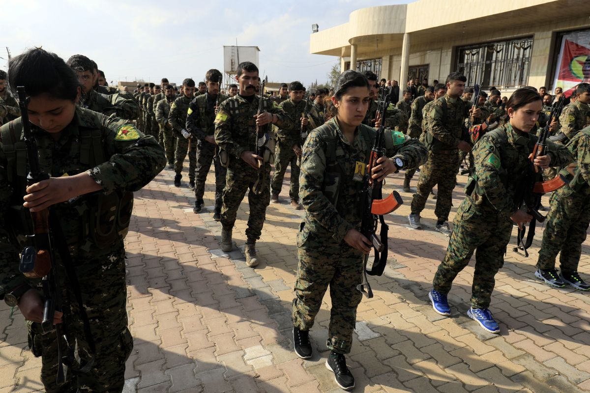 Members of the Kurdish People's Protection Units and Women's Protection Units attend the funeral of Kurdish fighters from the Syrian Democratic Forces that were killed in combat against the Islamic State.