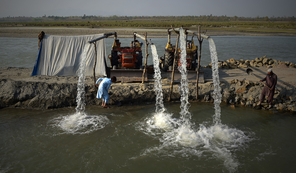 Pakistani farmers use tractors at the Kabul River to pump water used for field irrigation on the outskirts of Peshawar, Pakistan, on March 22nd, 2018.