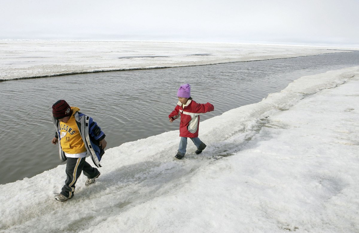 Inupiat Eskimo children play along the banks of the frozen Arctic Ocean on June 7th, 2006, in Browerville, Alaska.
