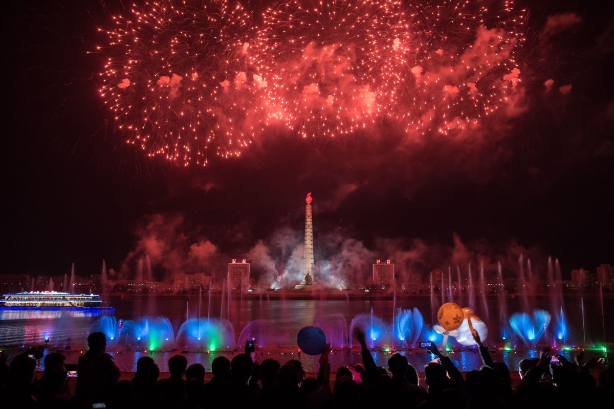 Spectators stand before a fireworks display over the Taedong River during celebrations marking the anniversary of the birth of late North Korean leader Kim Il Sung in Pyongyang, North Korea, on April 15th, 2018.