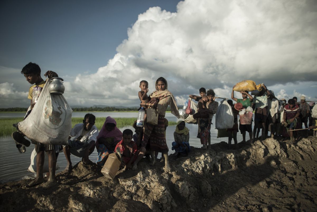 Rohingya refugees walk after crossing the Naf river from Myanmar into Bangladesh.