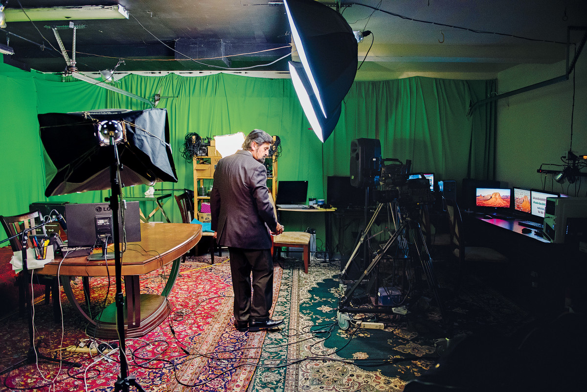 Haroon Ebrat stands in his makeshift studio.