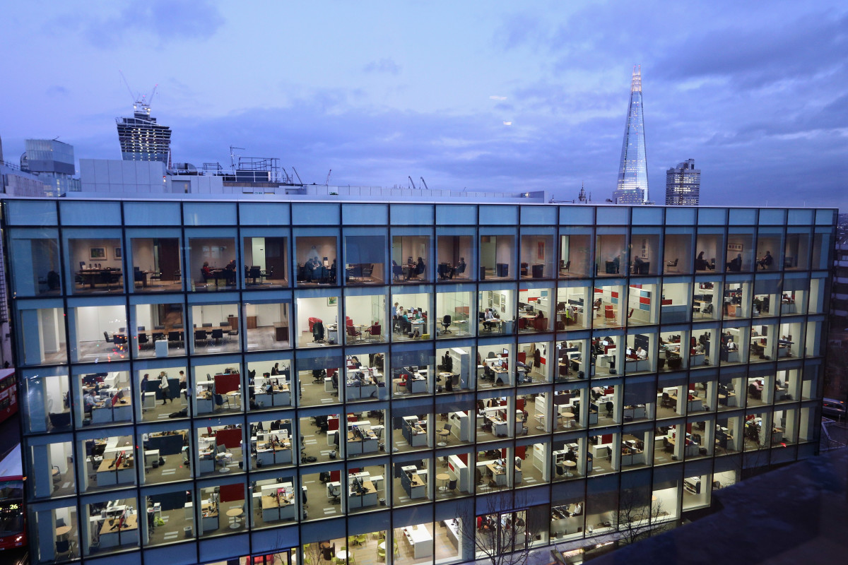 People work on various floors of an office building in London, England.