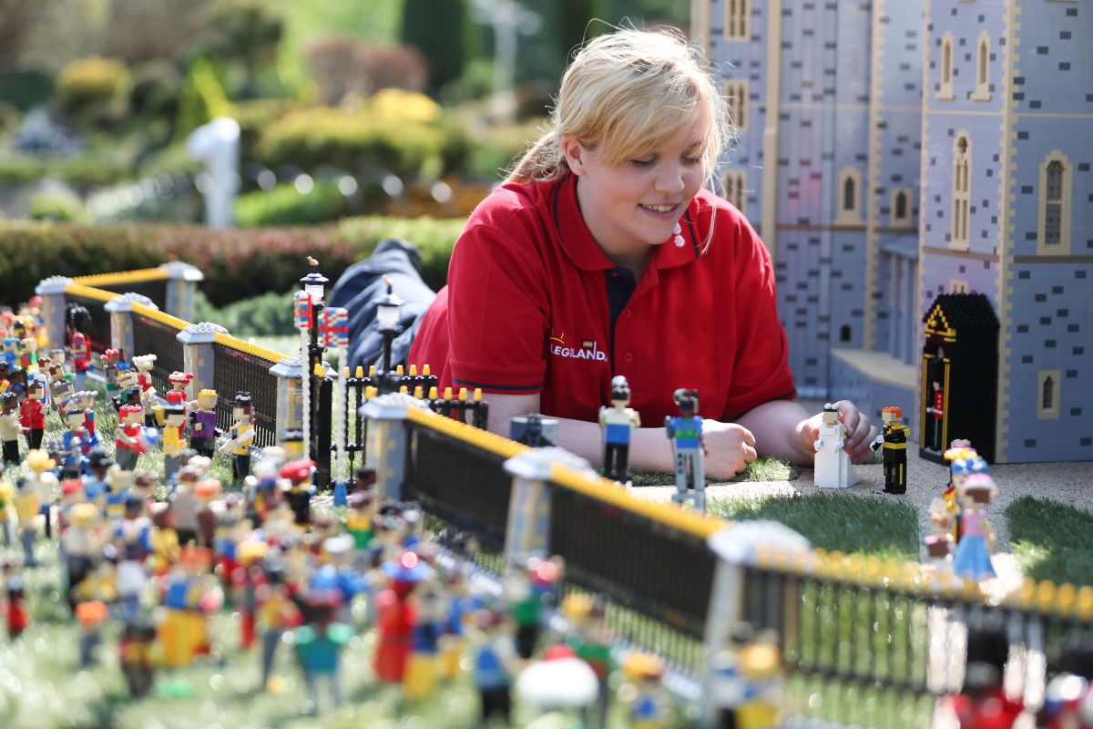 Legoland employee, Lucy, poses putting a Lego model of U.S. actress Meghan Markle in place next to her husband-to-be Britain's Prince Harry outside a Lego-brick model of Windsor Castle at Legoland in Windsor on May 8th, 2018, during a photo call for its attraction celebrating the upcoming royal wedding. Prince Harry and Markle will marry on May 19th at St. George's Chapel.