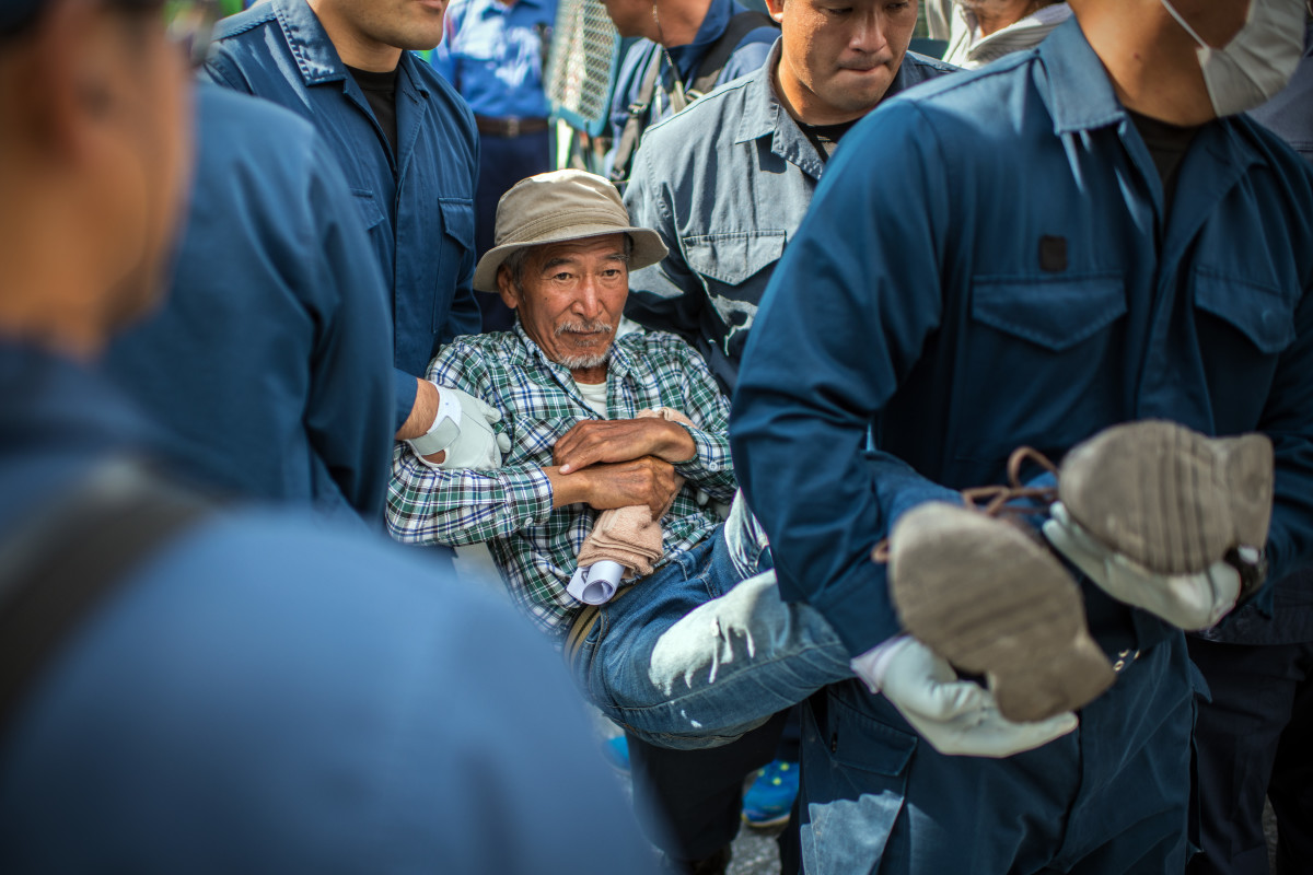 A protester is removed by police officers during a sit-in to block construction vehicles working on the expansion of Camp Schwab, a United States military base, on May 31st, 2018, in Nago, Okinawa prefecture, Japan. Demonstrators protesting against the U.S. military presence on the southern Japanese island of Okinawa have staged continuous protests outside Camp Schwab to block construction vehicles as the camp is expanded to accommodate the relocation of an airbase in nearby Henoko.