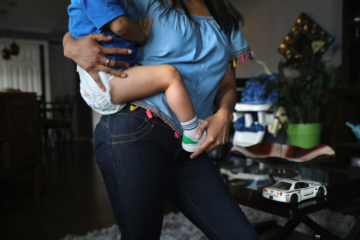 An undocumented immigrant from Peru holds her son at their home on June 6th, 2017, in Thornton, Colorado.