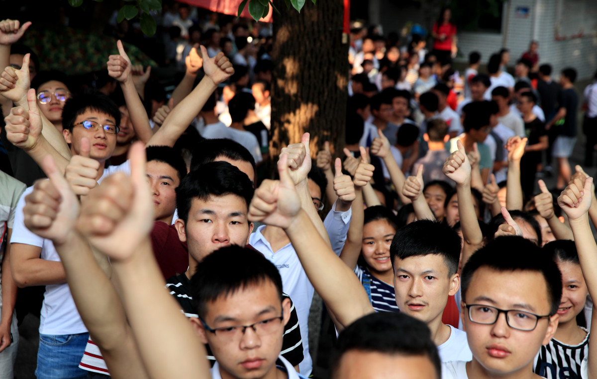 Candidates cheer for themselves before sitting the National College Entrance Examination (a.k.a. Gaokao) outside an exam site on June 7th, 2018, in Luzhou, Sichuan Province of China. About 9.75 million Chinese high school students will take the 2018 National College Entrance Examination.