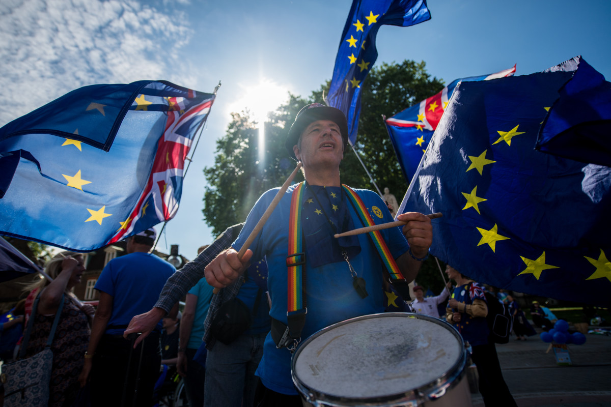A man bangs a drum as anti-Brexit demonstrators gather outside the Houses of Parliament on June 11th, 2018, in London, England. The European Union withdrawal bill returned to the House of Commons for the first of two sessions in which members of parliament will consider amendments imposed by the Lords, and another set of fresh amendments.