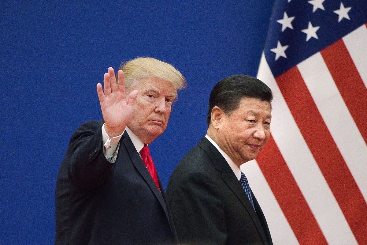 Donald Trump (L) and China's President Xi Jinping leave a business leaders event at the Great Hall of the People in Beijing.