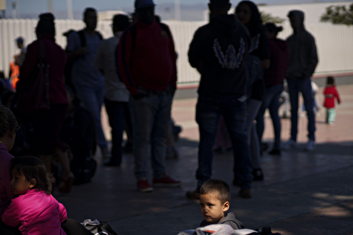 A child waits in line with his parents for an asylum hearing outside of the port of entry in Tijuana, Mexico, on June 18th, 2018.