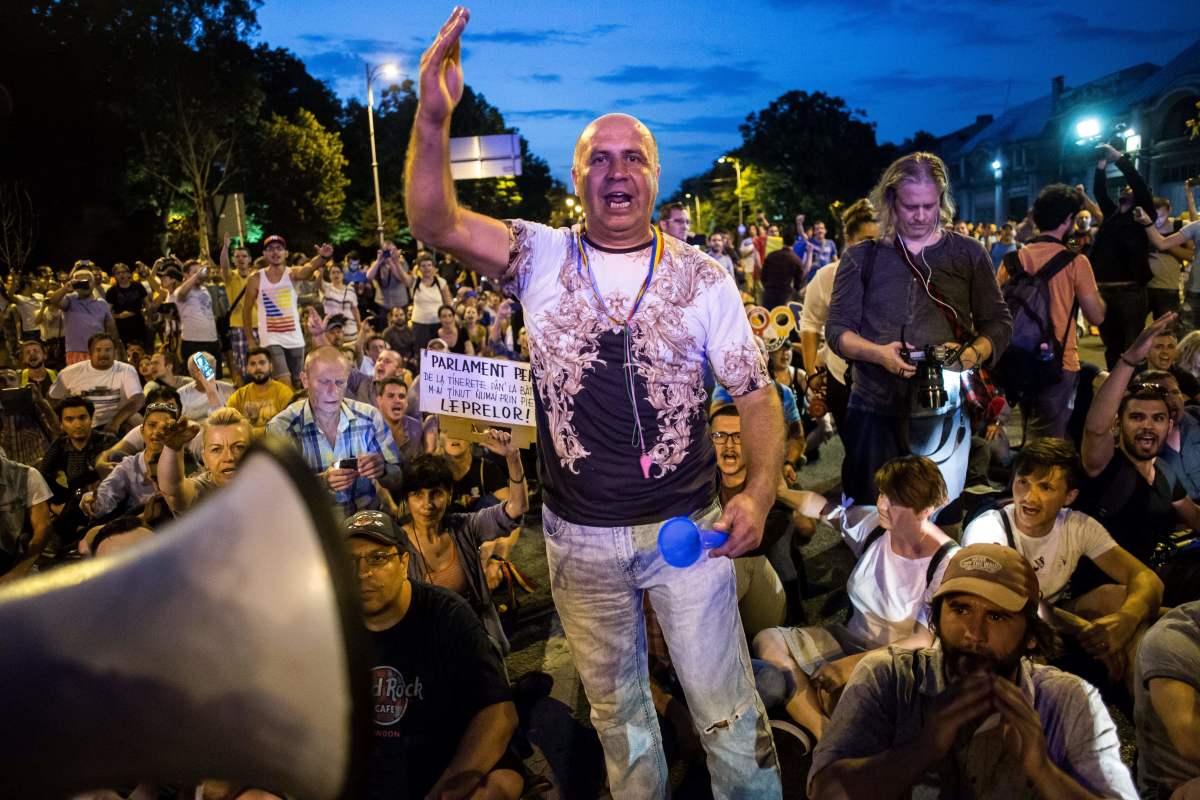 People participate in a protest in front of the prime minister's office in Bucharest on June 20th, 2018, against corruption and recent changes to the penal code which, they say, would severely impede the fight against corruption. Protesters chanted "We will not give in" and "Thieves."